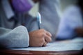 Students wearing mask for protect corona virus or covid-19 and doing exam in classroom with stress Royalty Free Stock Photo