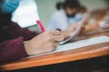 Students wearing mask for protect corona virus or covid-19 and doing exam in classroom with stress Royalty Free Stock Photo