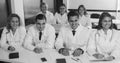 Students in white coats listen to lecture in audience Royalty Free Stock Photo