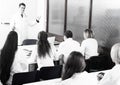 Students in white coats listen to lecture in audience Royalty Free Stock Photo