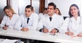 Students in white coats listen to lecture in audience Royalty Free Stock Photo