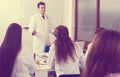 Students in white coats listen to lecture in audience Royalty Free Stock Photo