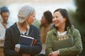 Students, women and friends outdoor on campus for university, conversation and walking to class with smile. College Royalty Free Stock Photo