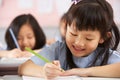 Students Working At Desks In Chinese School