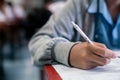 Students writing and reading exam answer sheets exercises in classroom of school with stress Royalty Free Stock Photo