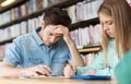 Students writing to notebooks in library Royalty Free Stock Photo