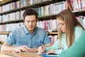 Students writing to notebooks in library Royalty Free Stock Photo