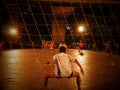 Students and young adults play soccer at night in Bangkok,