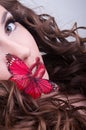 Studio beauty portrait with red butterfly