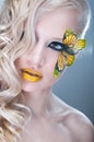 Studio beauty portrait with yellow butterfly