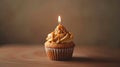 Studio capture of a delectable caramel cupcake topped with a single candle generative ai