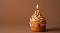 Studio capture of a delectable caramel cupcake topped with a single candle generative ai