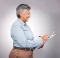 Studio, clipboard and mature happy woman writing checklist, inspection information or survey feedback. Happiness Royalty Free Stock Photo