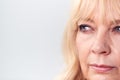 Studio Close Up Of Mature Woman Looking Suspicious And Distrustful