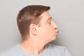 Portrait of funny mature man pouting his lips and blowing kiss