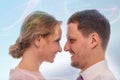 Studio close up portrait of a smiling man and woman people looking at each other with love on pink background Royalty Free Stock Photo