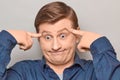 Portrait of thoughtful funny mature man touching temples with fingers Royalty Free Stock Photo