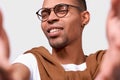 Closeup image of handsome African American young man smiling, wearing eyewear, looking at the camera and taking self portrait Royalty Free Stock Photo