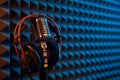 Studio condenser microphone with professional headphones acoustic panel