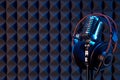 Studio condenser microphone with professional headphones acoustic panel Royalty Free Stock Photo