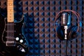 Studio microphone with professional headphones and black electric guitar Royalty Free Stock Photo