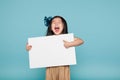 Studio of a delightful Asian girl holding a billboard Royalty Free Stock Photo