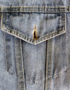 Studio denim open chest pocket of blue denim jacket close-up, clothes, jeans, buttonhole, fabric texture