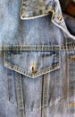 Studio denim open chest pocket and collar corner of blue denim jacket close-up, clothes, jeans, buttonhole, fabric texture