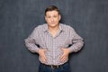 Portrait of dissatisfied man putting hands on his fat stomach Royalty Free Stock Photo