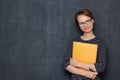 Portrait of happy friendly girl smiling and holding folder and pen Royalty Free Stock Photo