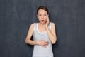 Studio portrait of shocked woman with widened eyes and open mouth Royalty Free Stock Photo