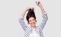 Studio image of cheerful brunette woman playing with hair smiling and laughing, posing over white background. Royalty Free Stock Photo