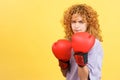 Rude girl in boxing gloves looking at camera Royalty Free Stock Photo