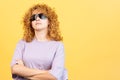 Rude woman with sunglasses standing with arms crossed Royalty Free Stock Photo