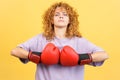 Rude woman in boxing gloves looking at camera Royalty Free Stock Photo