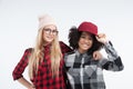 Studio lifestyle portrait of two best friends hipster girls going crazy and having great time together. Isolated on Royalty Free Stock Photo