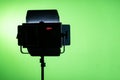 Studio light shining with green screen in the background. Silhouette of spot light for commercial work, motion picture, green