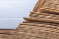 Studio lighting. Close-up side view of a huge stack of recycled paper. A huge stack of envelopes of recycled paper. Close-up