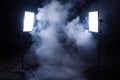 Studio Lighting Setup Two Softboxes on Stands Surrounded by Smoke Against Black Royalty Free Stock Photo