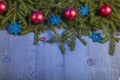 Studio lighting. wooden background in retro style. There are branches of a Christmas tree on it. New Year`s red balls. Copy space Royalty Free Stock Photo