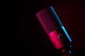 Studio microphone on dark background with neon lights Royalty Free Stock Photo