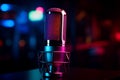 Studio microphone glows in neon light against a dark background Royalty Free Stock Photo