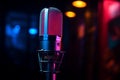 Studio microphone glows in neon light against a dark background Royalty Free Stock Photo