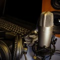 Studio microphone, headphones, speakers and computer. Home studio recording for sound mixing, sound design and music production Royalty Free Stock Photo