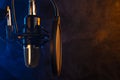 Studio microphone on mic stand against .Color disco background. Vocals and radio, podcasts, colored smoke Royalty Free Stock Photo