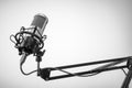 Studio microphone on the mic stand with gray background. Copy space Royalty Free Stock Photo