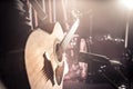 The Studio microphone records an acoustic guitar close-up. Beautiful blurred background of colored lanterns. Royalty Free Stock Photo