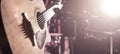 The Studio microphone records an acoustic guitar close-up. Beautiful blurred background of colored lanterns. Royalty Free Stock Photo