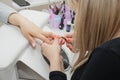 Cleaning and aligning the cuticle with forceps in the root of the nail Royalty Free Stock Photo