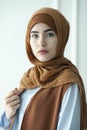 Studio photo of a beautiful young woman dressed oriental type in the Muslim style